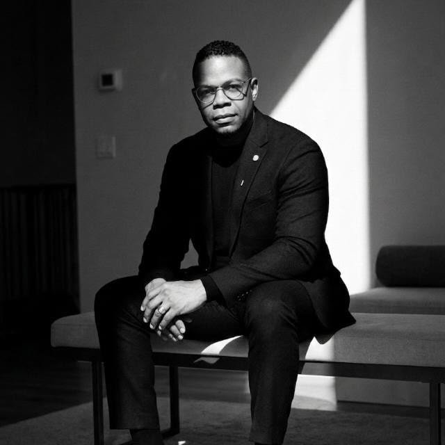Portrait of Dr. Pabel Reyes wearing a navy suit and white shirt